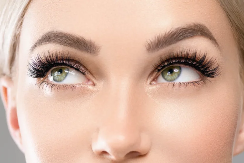 Close-up of lifted, tinted eyelashes and defined eyebrows after a lash lift and tint treatment at Astria Aesthetics.