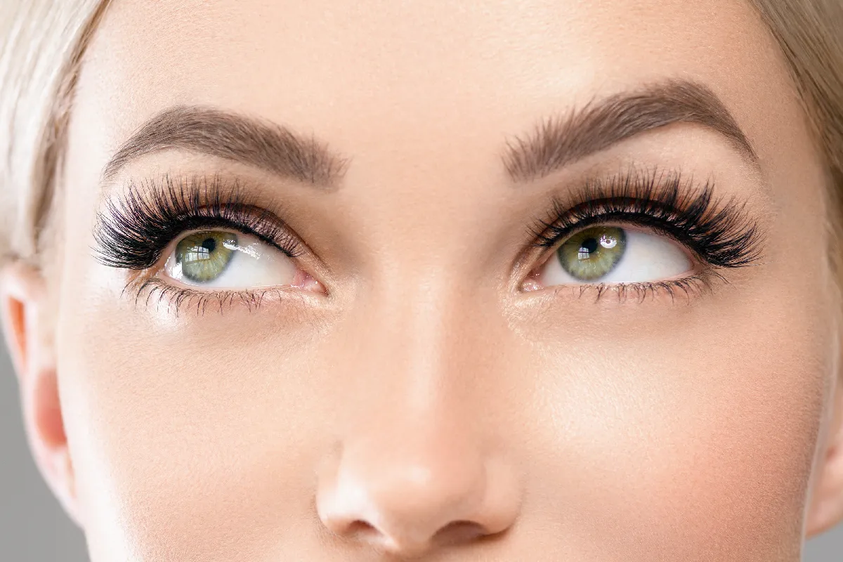 Close-up of lifted, tinted eyelashes and defined eyebrows after a lash lift and tint treatment at Astria Aesthetics.