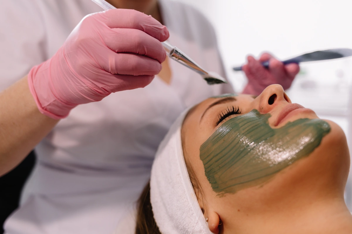 Woman receiving a green facial peel for skin renewal without traditional acids at Astria Aesthetics